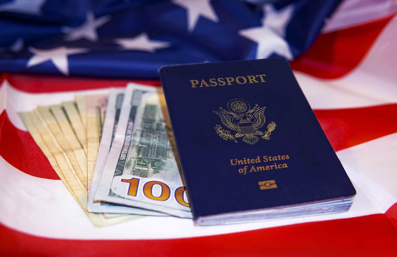 Visa Overstay USA: Shocking Consequences You Must Know 9 Passport, US dollar bills, and American flag background symbolizing immigration and financial success.